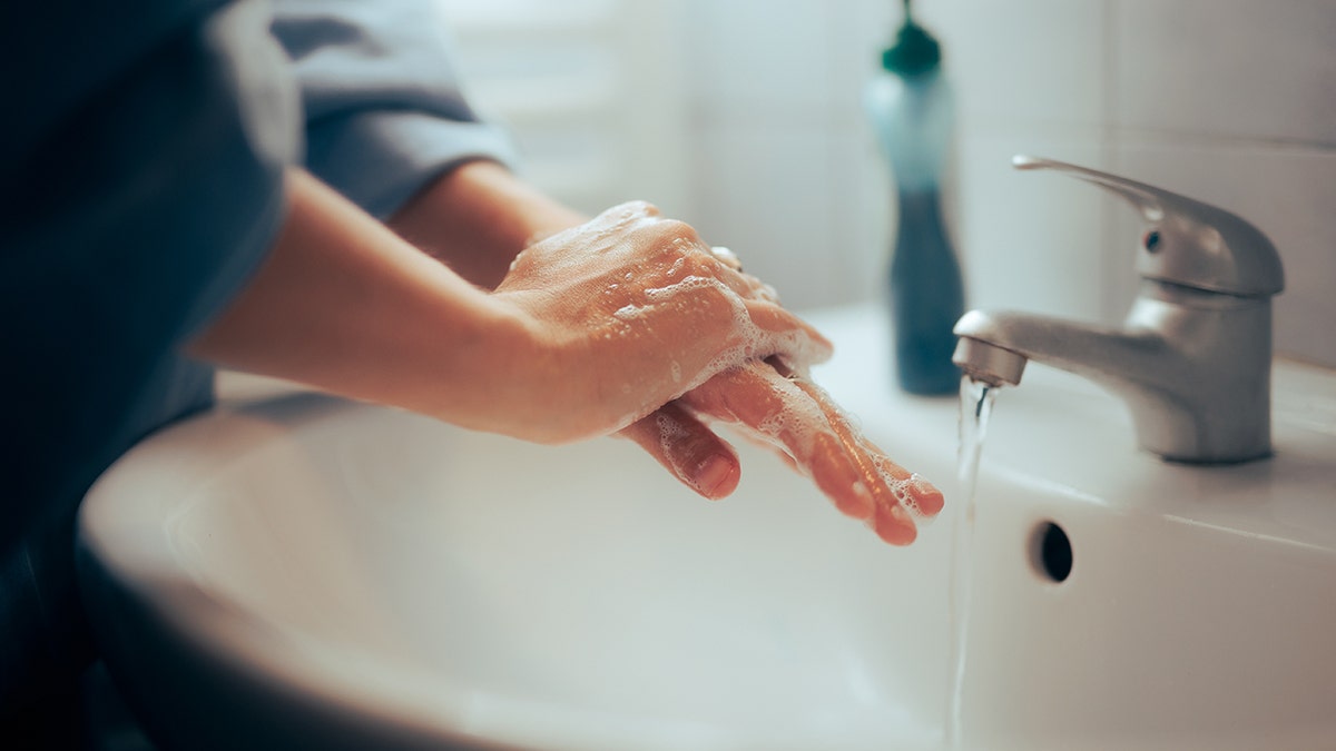 Person who washes hands in a toilet.