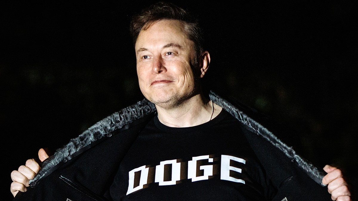 Elon Musk shows Black T -shirt with all white Doo's letters