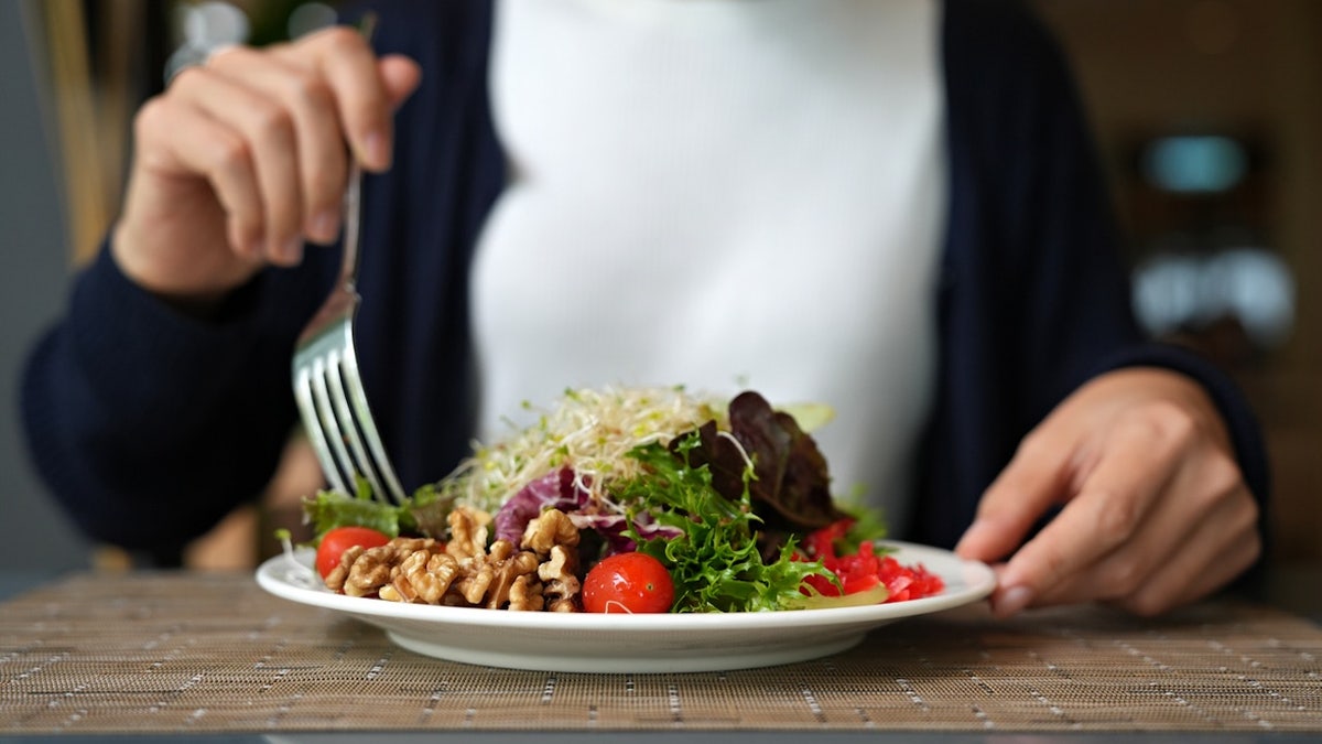 Woman eating salad