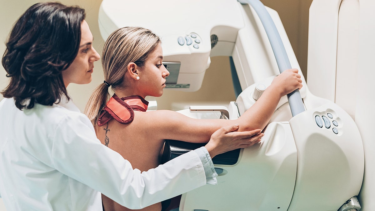 Doctor with patient in mammogram